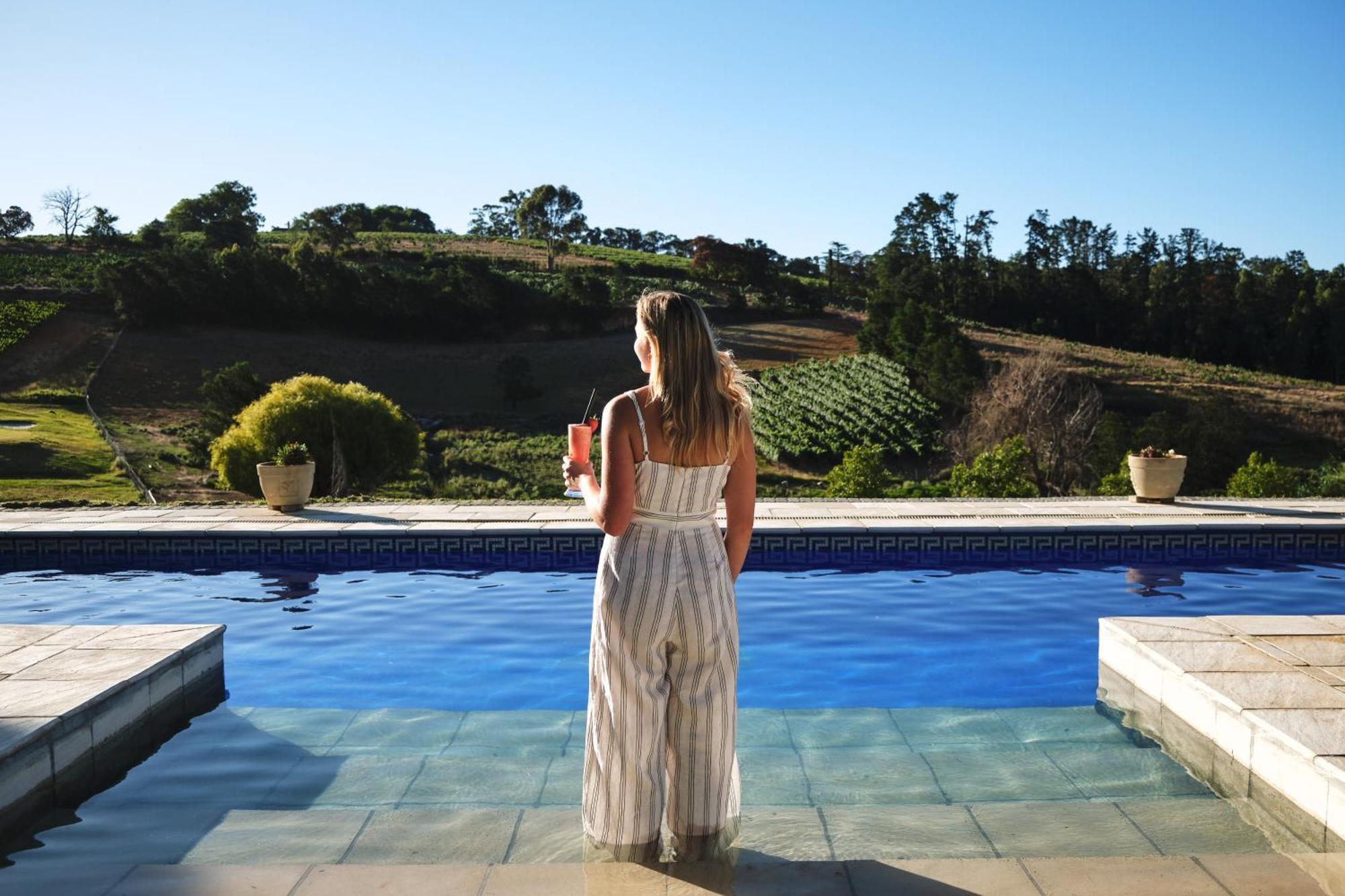 Alluvia Boutique Winery & Luxury Accommodation Stellenbosch Værelse billede A woman standing by a pool